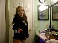 Cute young woman tries to suck on camera